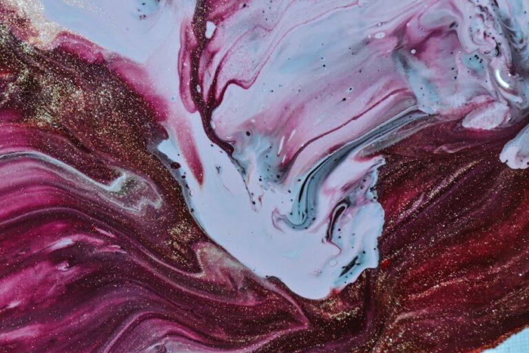 A dynamic abstract painting with swirling colors and glitter accents, showcasing vibrant maroon and white hues.