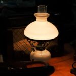 Elegant vintage oil lamp glowing warmly indoors, creating a nostalgic ambiance.