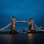 A stunning view of the illuminated Tower Bridge in London against a deep blue night sky.